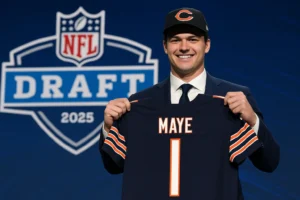 Drake Maye holding a Chicago Bears jersey on stage during the 2025 NFL Draft