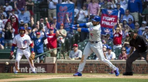 Chicago Cubs player swings at pitch vs Philadelphia Phillies at Wrigley Field, April 25, 2025 MLB game.