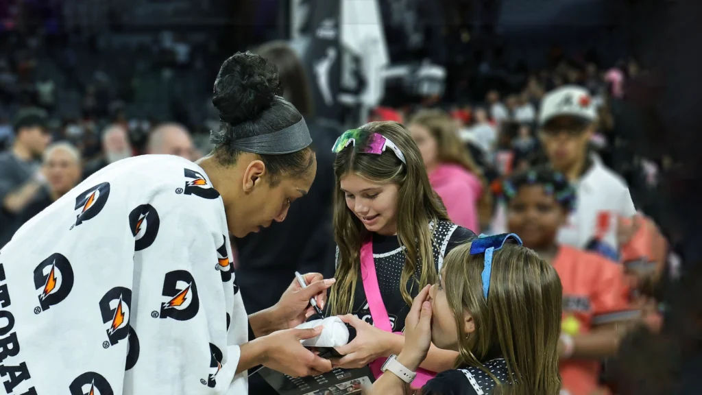 A'ja Wilson of the Las Vegas Aces signs autographs for fans after the Aces' 96-81 victory over the Los Angeles Sparks.