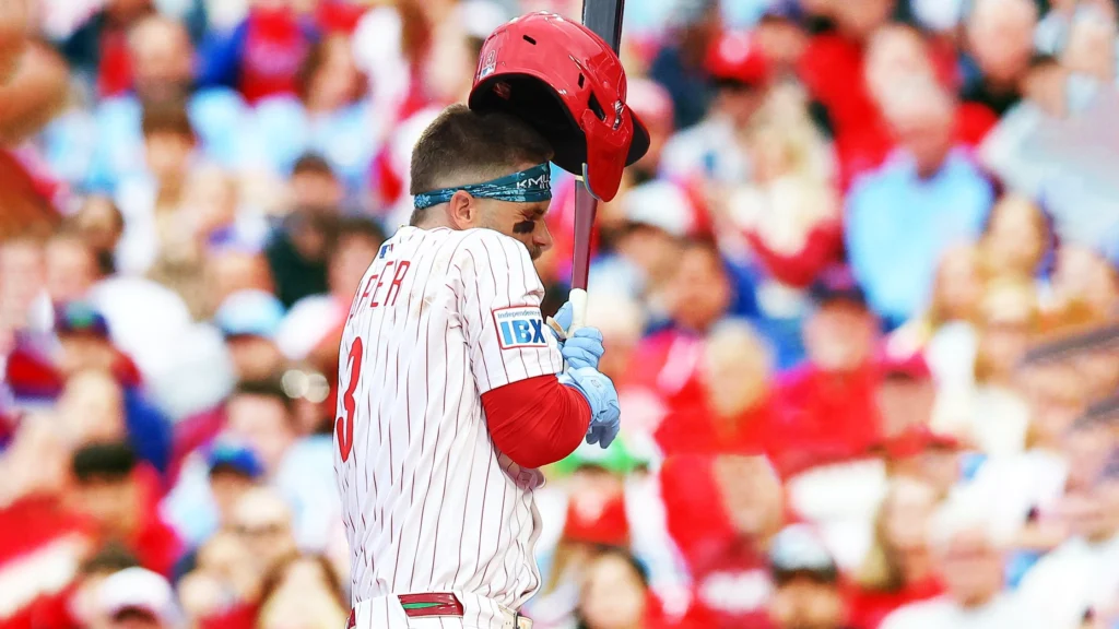 Bryce Harper of the Philadelphia Phillies is hit in the elbow by a pitch from Spencer Strider of the Atlanta Braves (not pictured) during the first inning of the game 