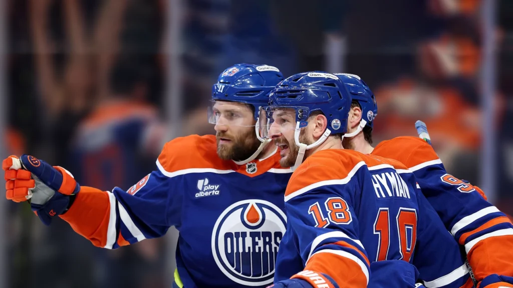 Leon Draisaitl and Zach Hyman celebrate a goal by Connor McDavid of the Edmonton Oilers during the second period against the Dallas Stars.