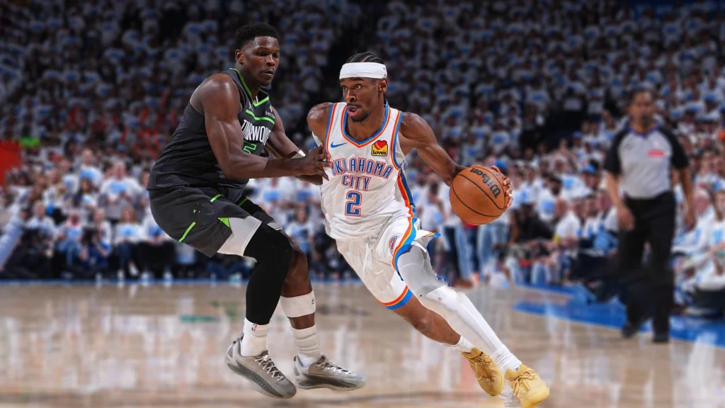 Shai Gilgeous-Alexander of the Oklahoma City Thunder handles the ball while Anthony Edwards of the Minnesota Timberwolves plays defense during the game One of the Western Conference Finals.