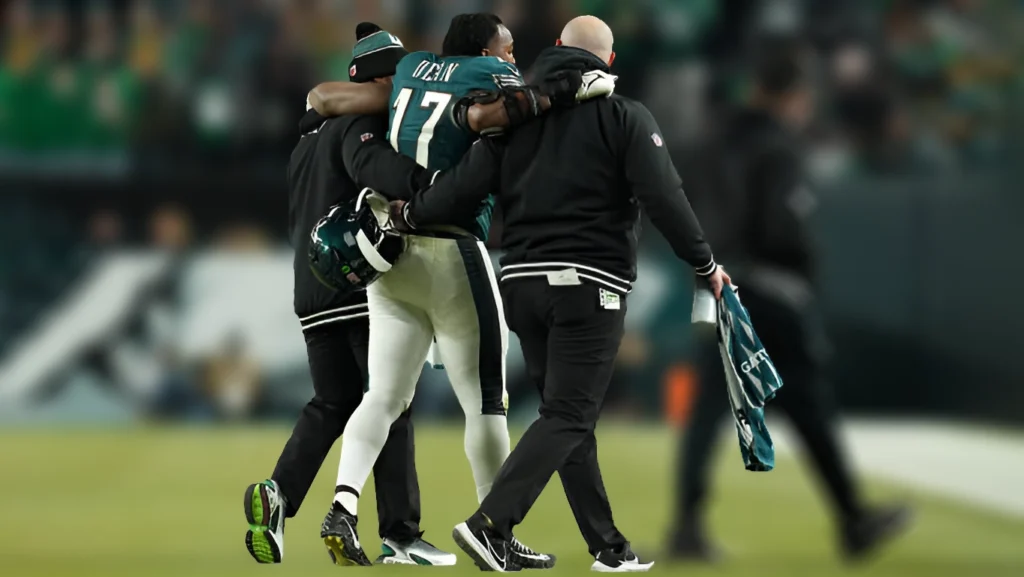 Nakobe Dean of the Philadelphia Eagles is helped off the field after injuring himself in the second quarter of the NFC Wild Card Playoff against the Green Bay Packers at Lincoln Financial Field on January 12, 2025.