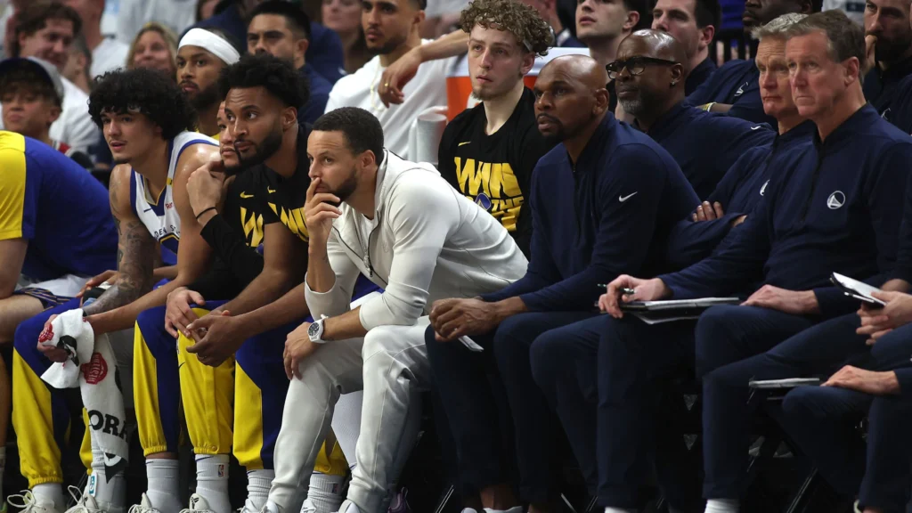 Stephen Curry of the Golden State Warriors watches from the bench against the Minnesota Timberwolves during the fourth quarter in Game Five of the Western Conference Second Round NBA Playoffs.