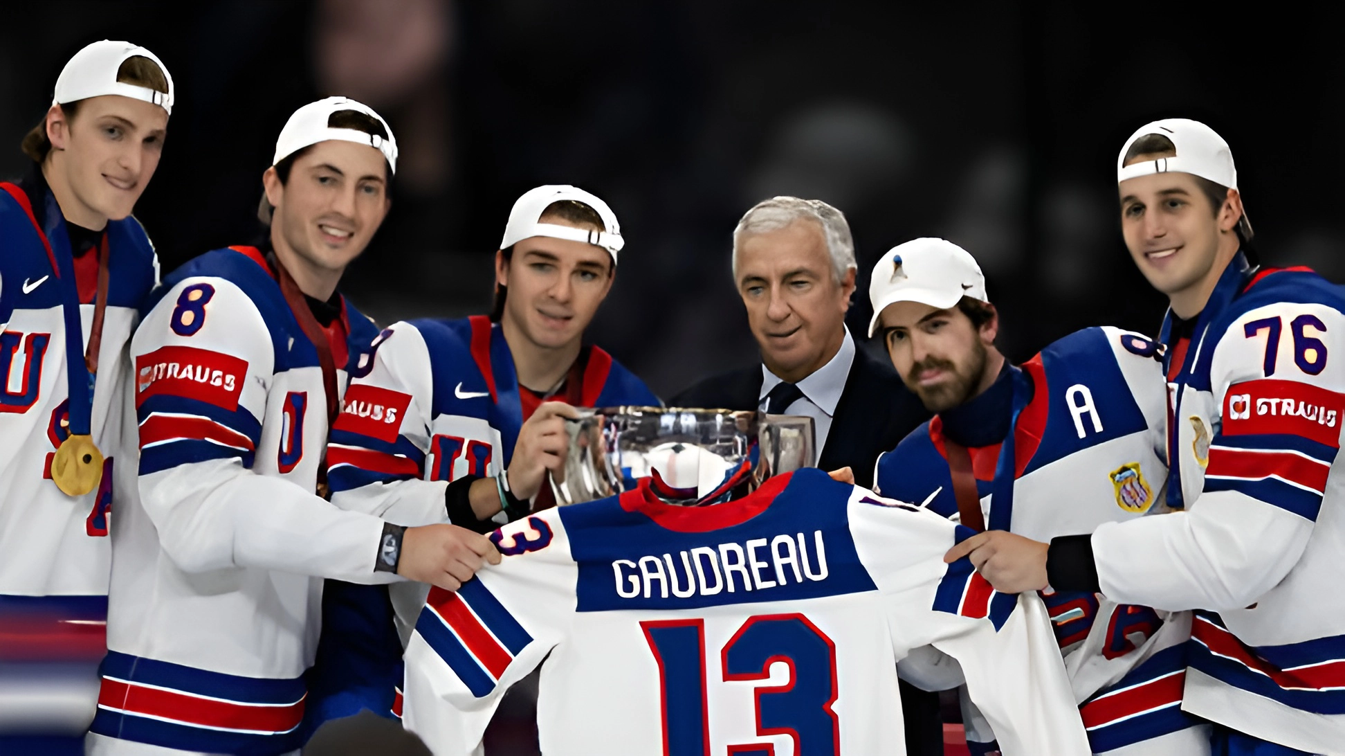: First place winners Team USA pose for a photo with a jersey honoring the late Johnny Gaudreau after their gold medal match win against Switzerland in the 2025 Ice Hockey World Championship.