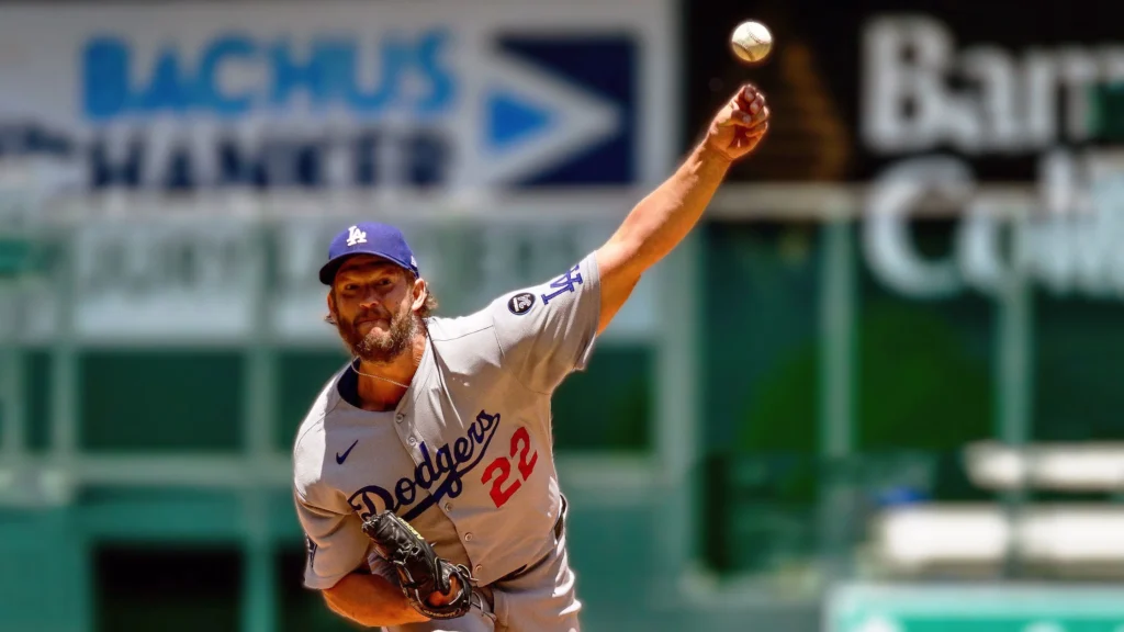 Clayton Kershaw, wearing a Dodgers uniform with number 22, throws a baseball on the mound during a game.