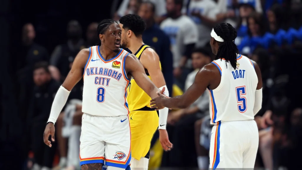 Jalen Williams (left, #8) high-fives teammate Luguentz Dort (#5) during the Oklahoma City Thunder's dominant Game 5 victory over the Indiana Pacers in the NBA Finals.