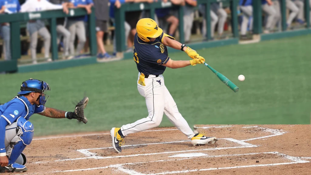 West Virginia Mountaineers catcher Logan Sauve (33) hits a solo home run during a NCAA Division 1 college regional baseball playoff game against the Kentucky Wildcats.