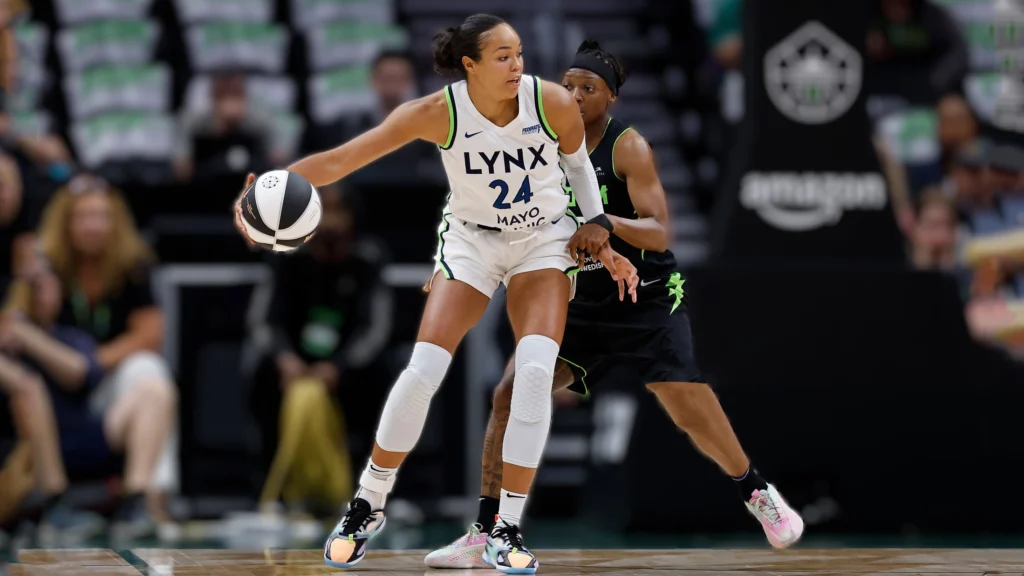Napheesa Collier of the Minnesota Lynx controls the ball against Erica Wheeler of the Seattle Storm during the game.