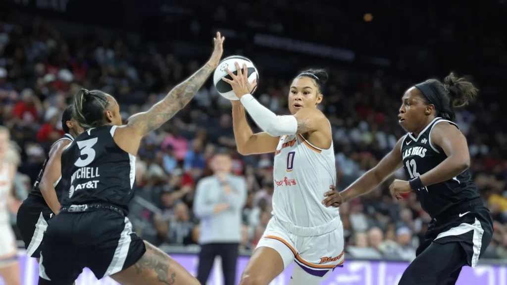 Satou Sabally of the Phoenix Mercury drives against Tiffany Mitchell and Chelsea Gray of the Las Vegas Aces in the second quarter of their game.