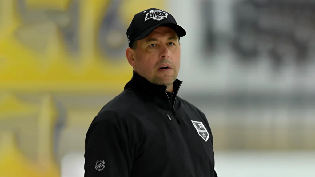 Former NHL player and now coach Marco Sturm is seen here, during his time as an assistant coach for the Los Angeles Kings, as indicated by the "KINGS" logo on his cap
